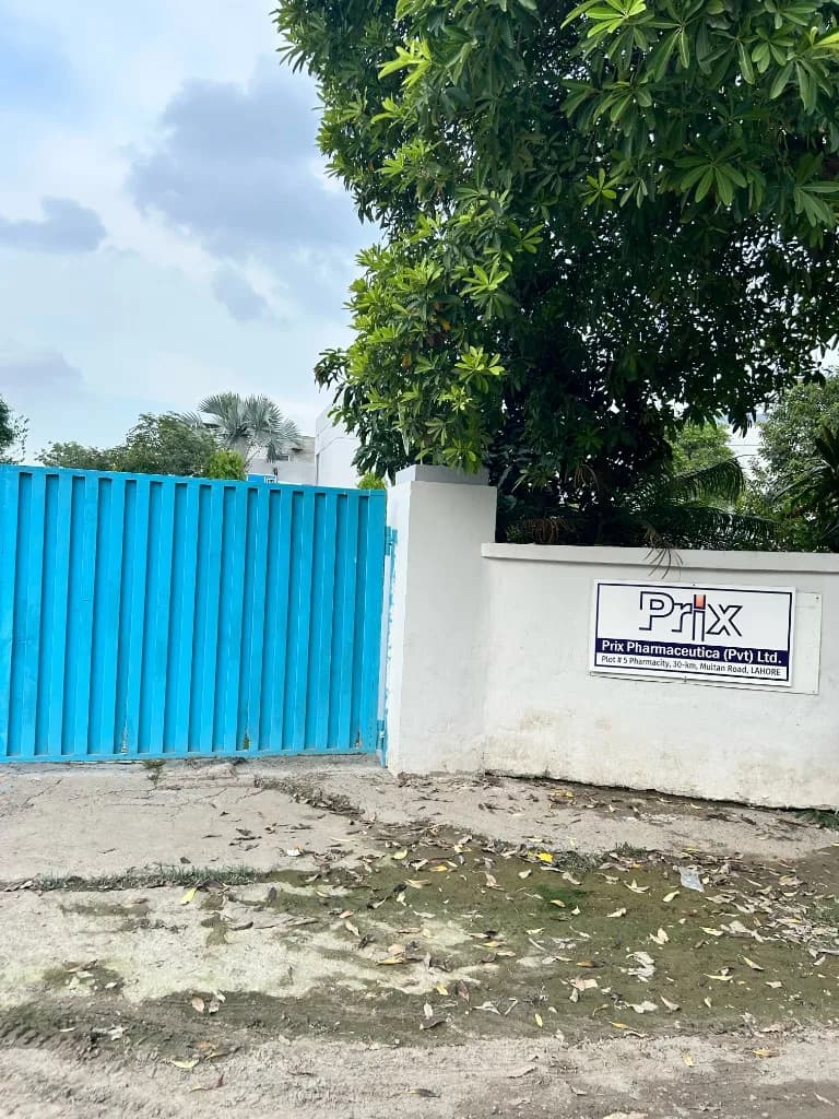 Prix Pharmaceutica facility entrance with company sign and blue gate