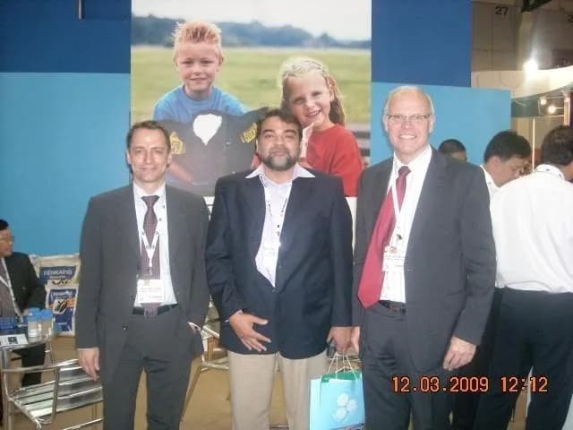 Professionals networking on the exhibition floor at an animal health trade show in 2009
