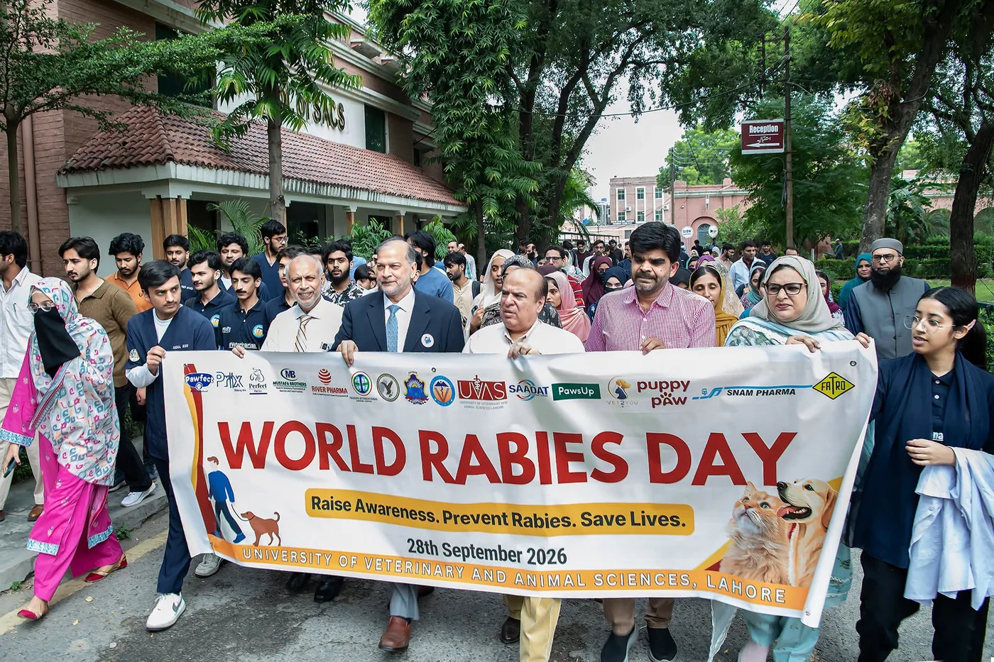 World Rabies Day awareness walk participants with banner at UVAS Lahore