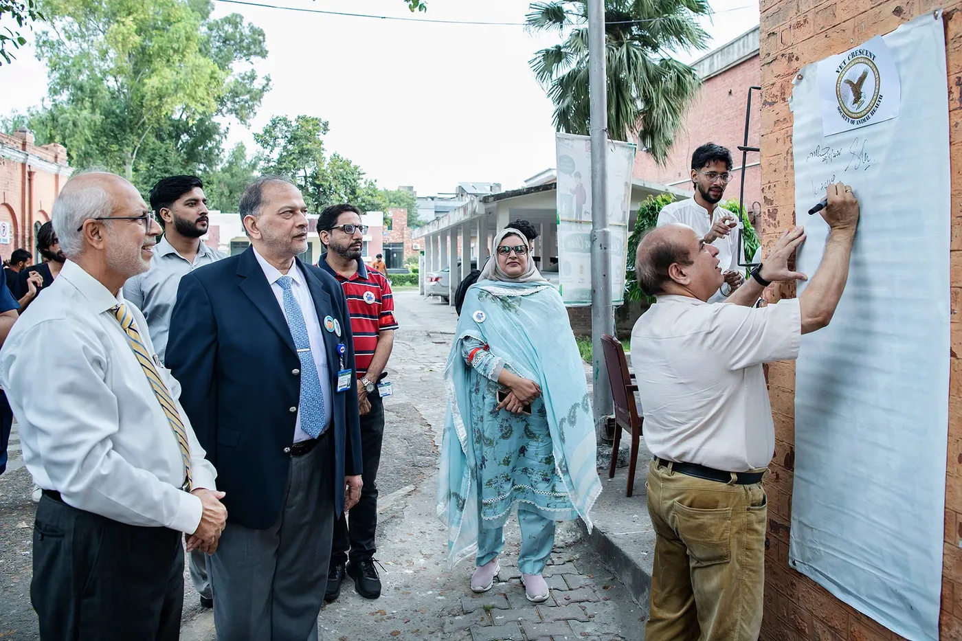 Participants signing an event banner during the World Rabies Day programme at UVAS