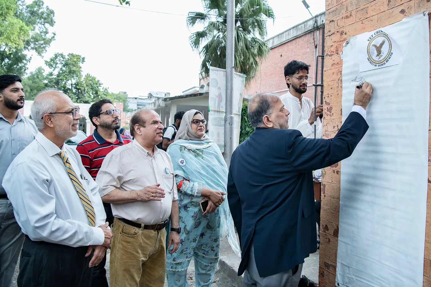 Guests observing banner signing during the World Rabies Day event at UVAS Lahore